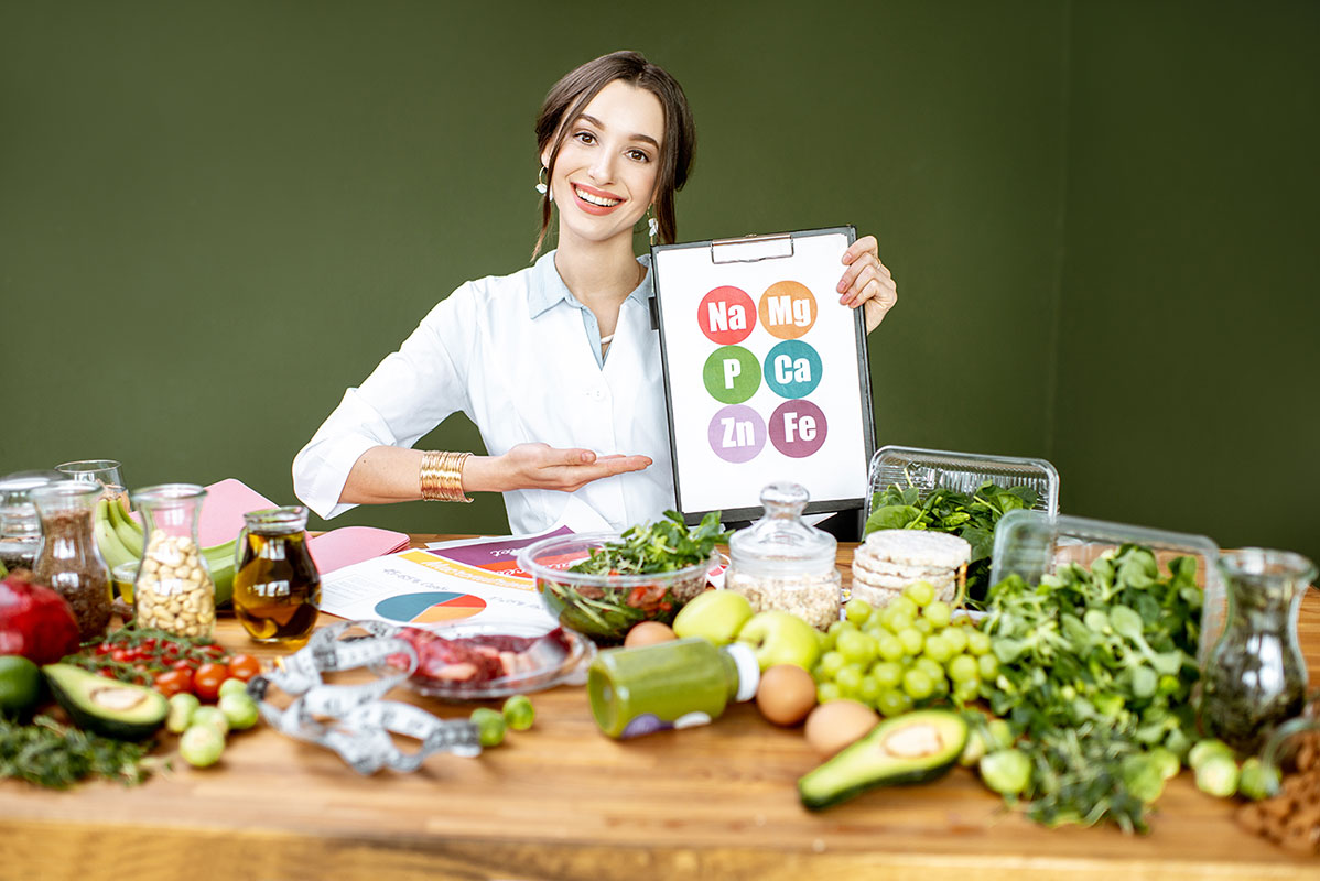 dietitian-with-vitamin-sheme-at-the-table-full-of-resize.jpg