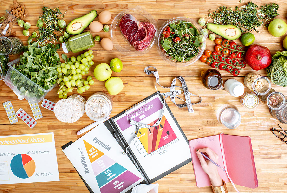 writing-a-diet-plan-on-the-table-full-of-healthy-resize.jpg